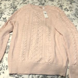 Rose color cable knit sweater.